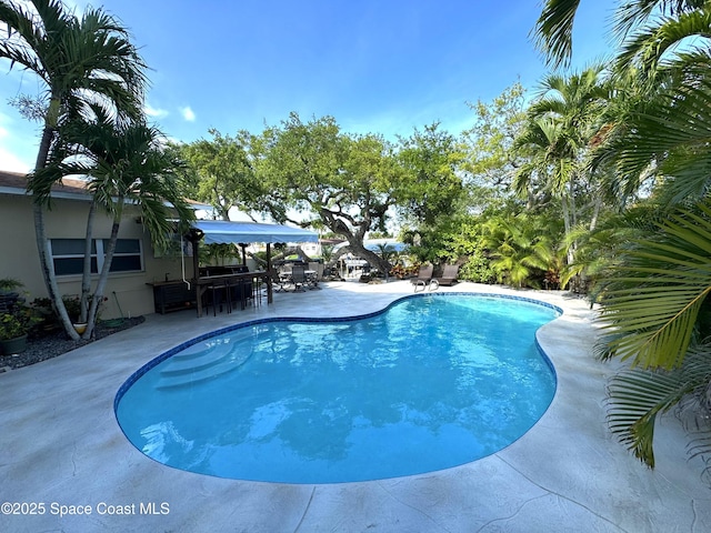 52 Riverview Ln, Cocoa Beach, FL 32931 - swimming pool with a patio and outdoor dining space