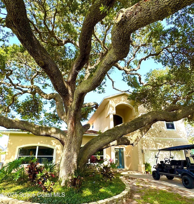52 Riverview Ln, Cocoa Beach, FL 32931 - view of front of home featuring stucco siding and an attached garage