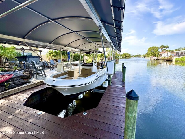 52 Riverview Ln, Cocoa Beach, FL 32931 - dock featuring boat lift and a water view