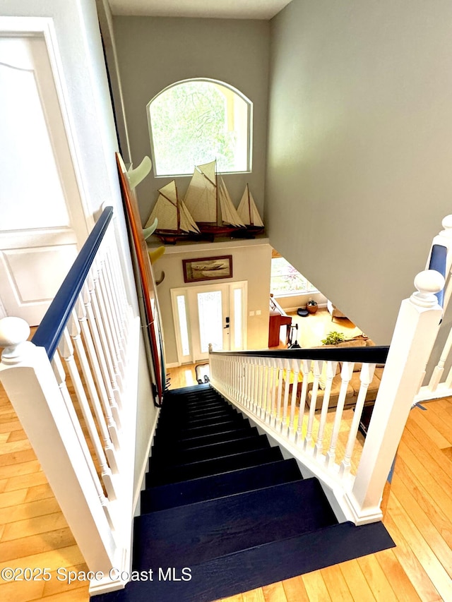 52 Riverview Ln, Cocoa Beach, FL 32931 - staircase with hardwood / wood-style flooring and a high ceiling