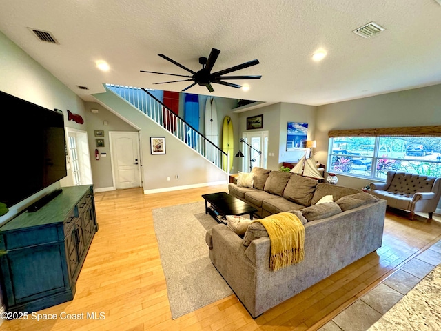 52 Riverview Ln, Cocoa Beach, FL 32931 - living area featuring stairs, light wood finished floors, a textured ceiling, ceiling fan, and recessed lighting