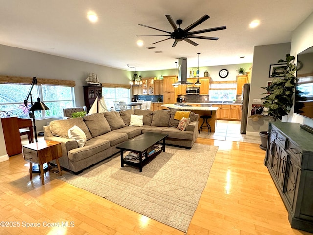 52 Riverview Ln, Cocoa Beach, FL 32931 - living area with ceiling fan, plenty of natural light, recessed lighting, and light wood-style flooring