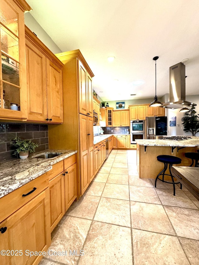 52 Riverview Ln, Cocoa Beach, FL 32931 - kitchen with island exhaust hood, stainless steel appliances, a breakfast bar, tasteful backsplash, and light stone countertops