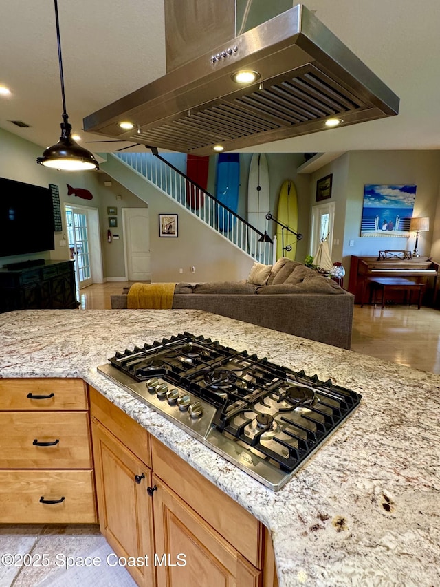 52 Riverview Ln, Cocoa Beach, FL 32931 - kitchen with open floor plan, exhaust hood, stainless steel gas stovetop, light stone counters, and recessed lighting