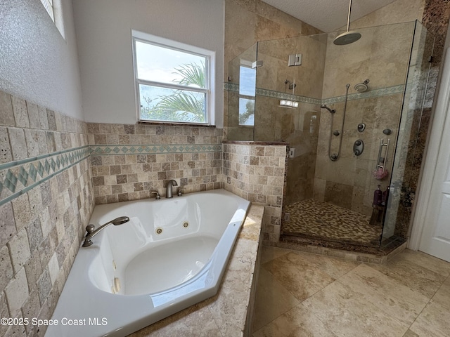 52 Riverview Ln, Cocoa Beach, FL 32931 - bathroom featuring a shower stall, a tub with jets, and tile walls