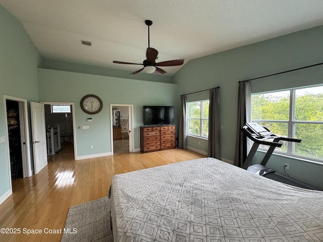 52 Riverview Ln, Cocoa Beach, FL 32931 - bedroom featuring lofted ceiling, light wood-type flooring, and a ceiling fan