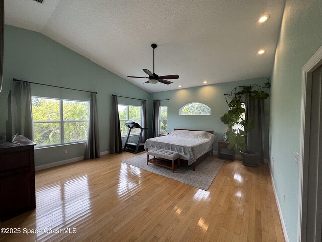 52 Riverview Ln, Cocoa Beach, FL 32931 - bedroom with lofted ceiling, light wood-type flooring, a textured ceiling, recessed lighting, and a ceiling fan