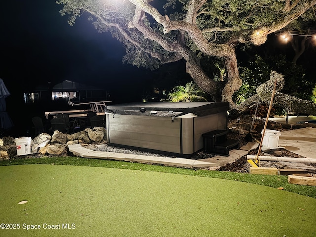 52 Riverview Ln, Cocoa Beach, FL 32931 - yard at night with a hot tub