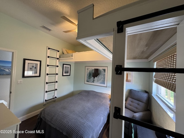 52 Riverview Ln, Cocoa Beach, FL 32931 - bedroom with a ceiling fan and a textured ceiling
