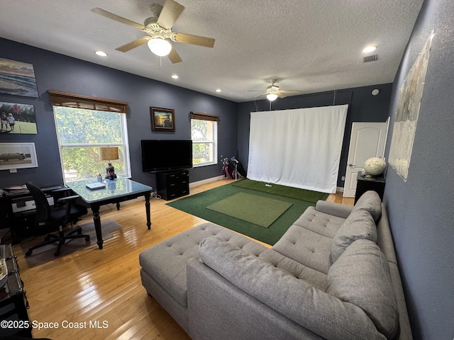 52 Riverview Ln, Cocoa Beach, FL 32931 - living area with golf simulator, wood finished floors, ceiling fan, a textured ceiling, and recessed lighting