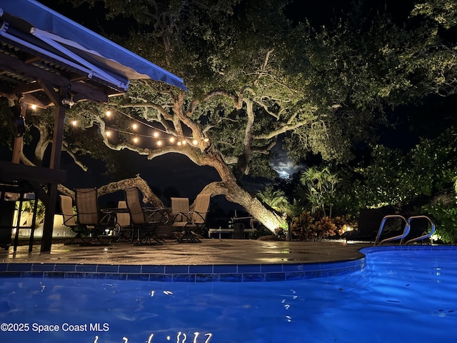 52 Riverview Ln, Cocoa Beach, FL 32931 - pool at twilight with an outdoor pool