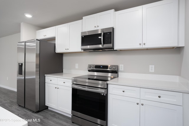 899 Brickell St SE, Palm Bay, FL 32909 - kitchen featuring appliances with stainless steel finishes, wood finished floors, white cabinetry, and recessed lighting