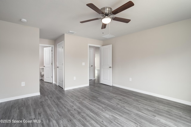 899 Brickell St SE, Palm Bay, FL 32909 - unfurnished bedroom with dark wood-style flooring, ensuite bath, and a ceiling fan