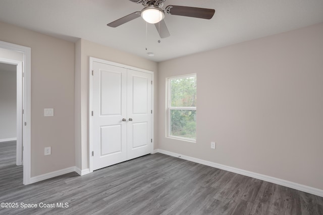 899 Brickell St SE, Palm Bay, FL 32909 - unfurnished bedroom with wood finished floors, a closet, and a ceiling fan