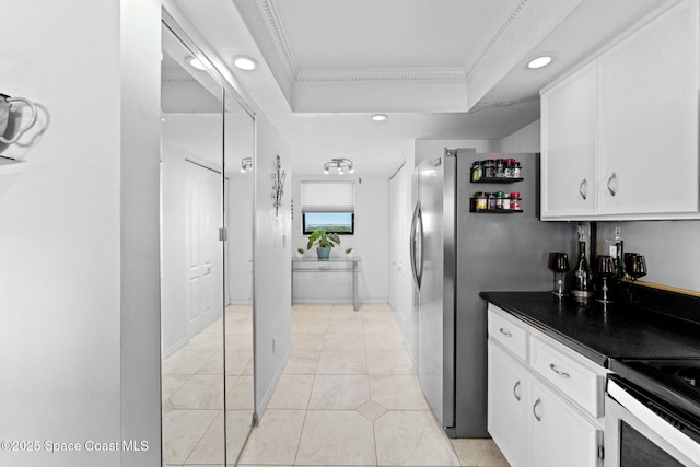 830 N Atlantic Ave Unit 903, Cocoa Beach, FL 32931 - kitchen featuring white cabinets, dark countertops, a raised ceiling, crown molding, and recessed lighting
