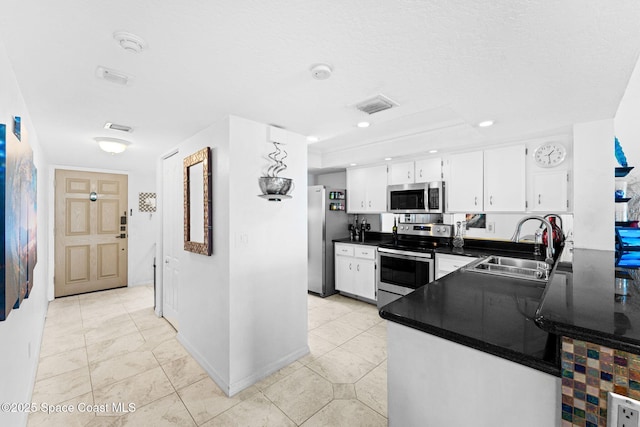 830 N Atlantic Ave Unit 903, Cocoa Beach, FL 32931 - kitchen featuring appliances with stainless steel finishes, dark countertops, white cabinets, and recessed lighting