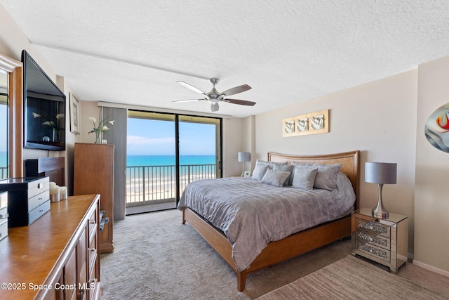 830 N Atlantic Ave Unit 903, Cocoa Beach, FL 32931 - carpeted bedroom with access to exterior, a textured ceiling, and a ceiling fan