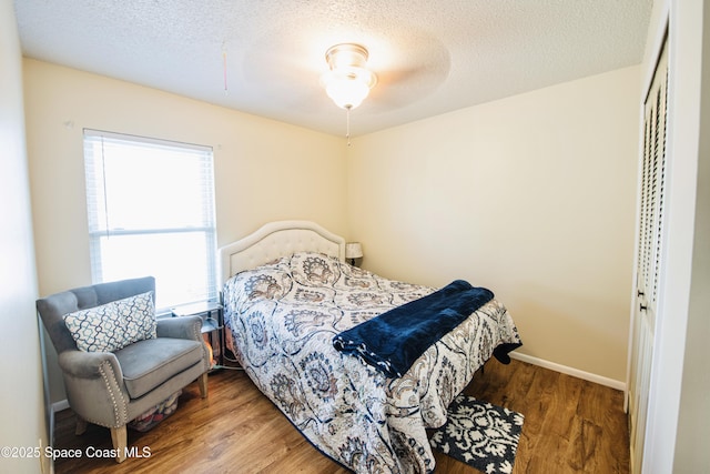 1139 Price Ave NW, Palm Bay, FL 32907 - bedroom featuring a textured ceiling, wood finished floors, and a closet