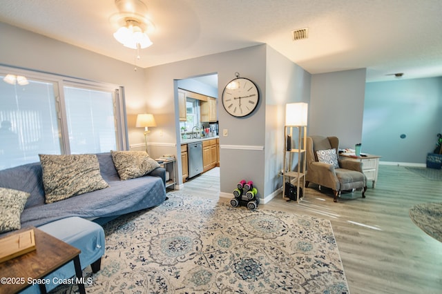 1139 Price Ave NW, Palm Bay, FL 32907 - living area featuring light wood finished floors and ceiling fan