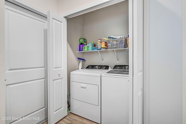 3930 Playa Del Sol Dr Unit 106, Rockledge, FL 32955 - laundry room with washer and dryer and light wood-style floors