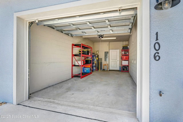 3930 Playa Del Sol Dr Unit 106, Rockledge, FL 32955 - garage with electric panel and a garage door opener
