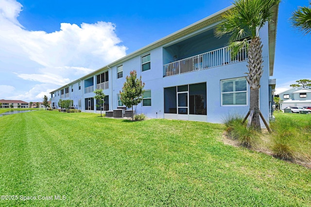 3930 Playa Del Sol Dr Unit 106, Rockledge, FL 32955 - rear view of property with stucco siding and a yard