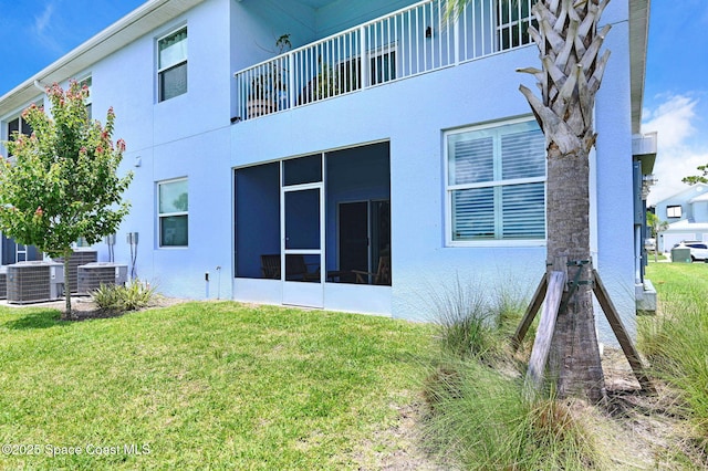 3930 Playa Del Sol Dr Unit 106, Rockledge, FL 32955 - view of side of home with a lawn and stucco siding