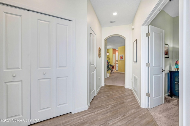 3930 Playa Del Sol Dr Unit 106, Rockledge, FL 32955 - hall with arched walkways and light wood-style flooring