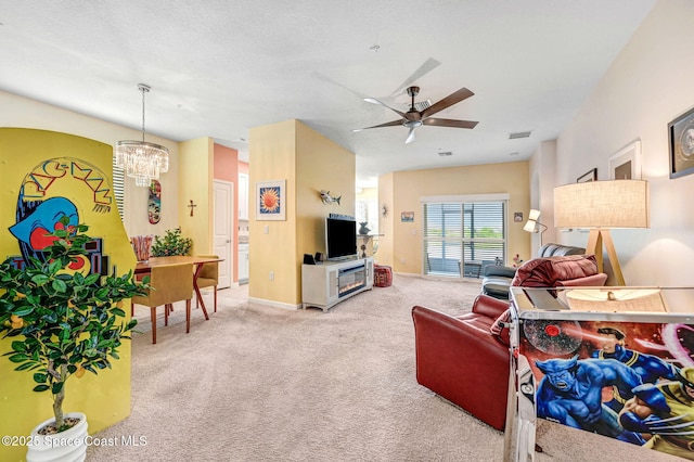 3930 Playa Del Sol Dr Unit 106, Rockledge, FL 32955 - carpeted living area featuring a ceiling fan and a chandelier