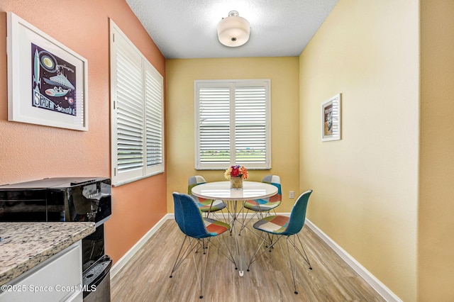 3930 Playa Del Sol Dr Unit 106, Rockledge, FL 32955 - dining space with light wood-type flooring and a textured ceiling