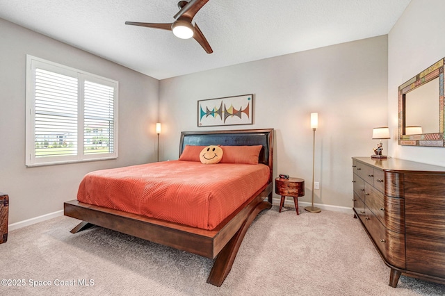 3930 Playa Del Sol Dr Unit 106, Rockledge, FL 32955 - bedroom with light carpet, a ceiling fan, and a textured ceiling