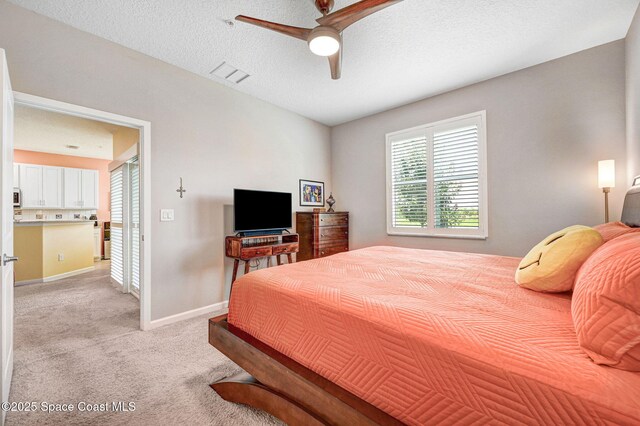 3930 Playa Del Sol Dr Unit 106, Rockledge, FL 32955 - bedroom with light colored carpet, a ceiling fan, and a textured ceiling