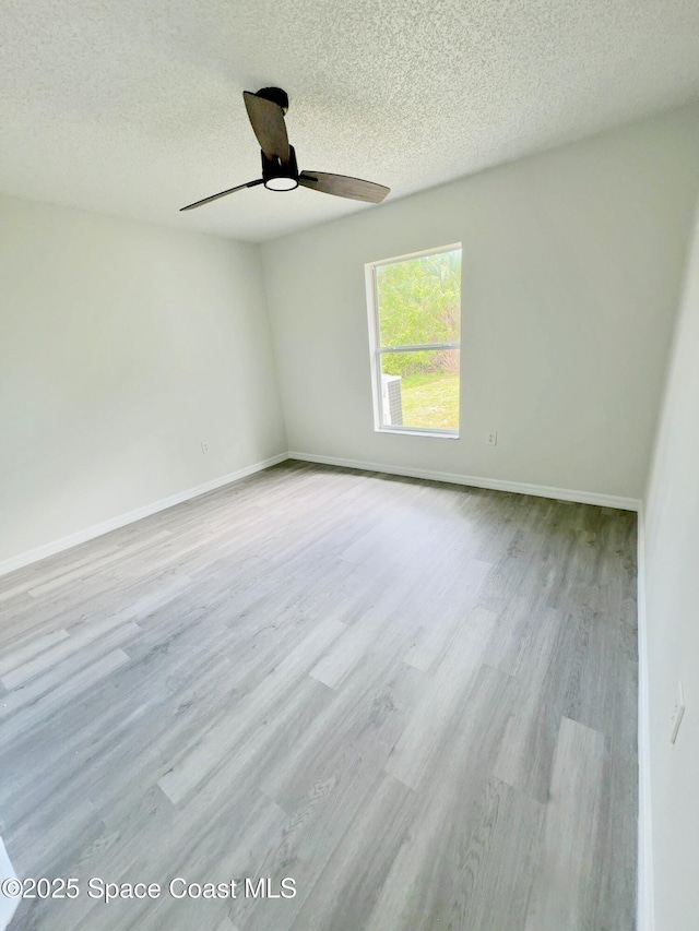 3162 San Salvador Ave, Palm Bay, FL 32909 - spare room with a textured ceiling, wood finished floors, and a ceiling fan