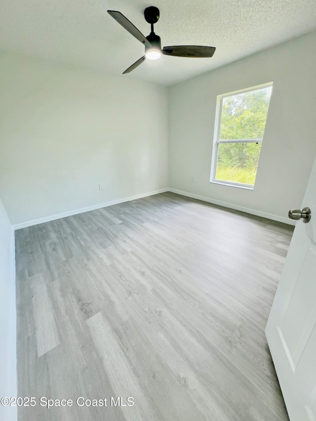 3162 San Salvador Ave, Palm Bay, FL 32909 - spare room with wood finished floors, a ceiling fan, and a textured ceiling