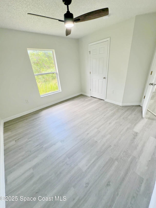 3162 San Salvador Ave, Palm Bay, FL 32909 - empty room featuring wood finished floors, ceiling fan, and a textured ceiling