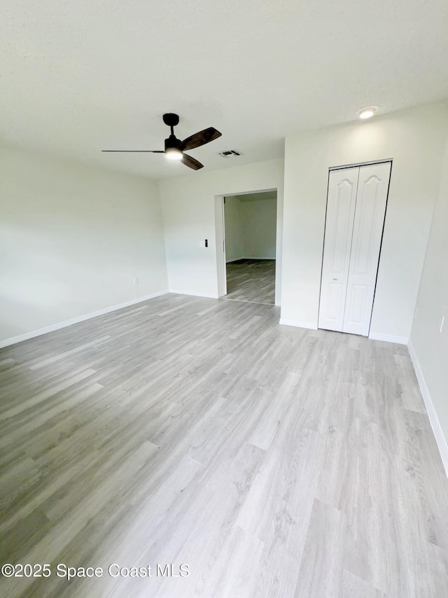 3162 San Salvador Ave, Palm Bay, FL 32909 - unfurnished bedroom featuring a closet, light wood-type flooring, and a ceiling fan