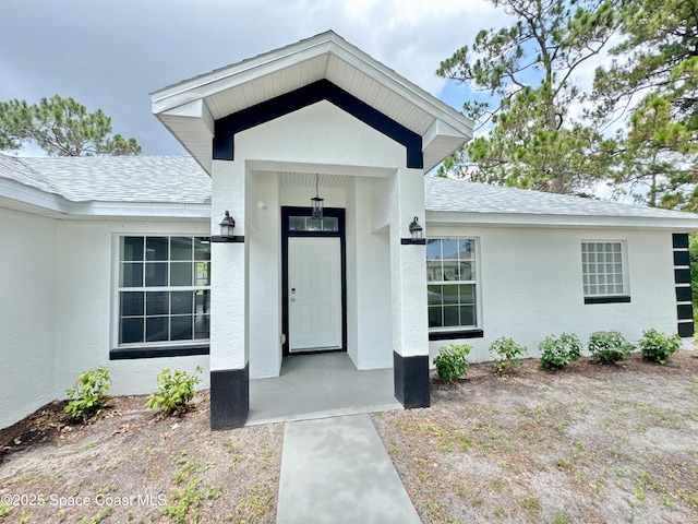 3162 San Salvador Ave, Palm Bay, FL 32909 - doorway to property with roof with shingles and stucco siding