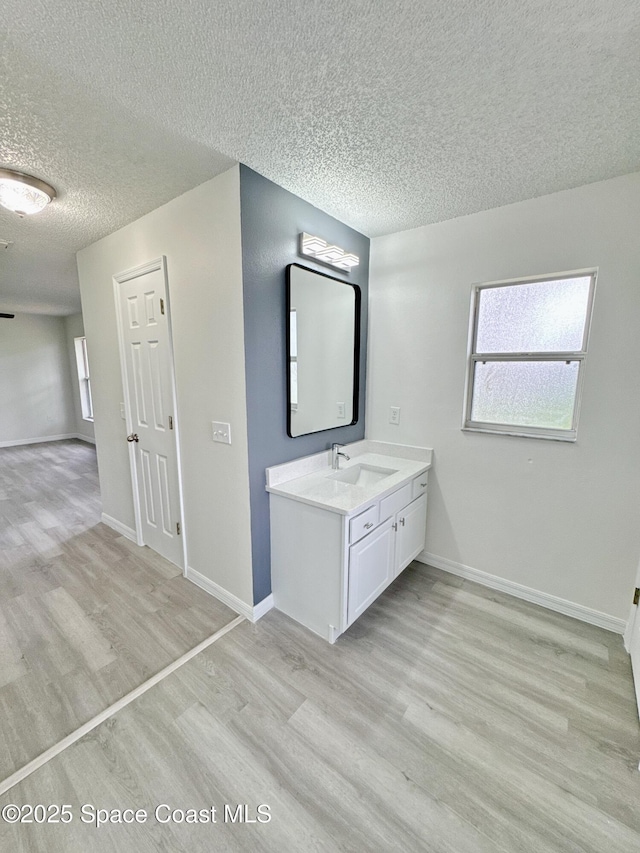 3162 San Salvador Ave, Palm Bay, FL 32909 - bathroom featuring wood finished floors, a textured ceiling, and vanity