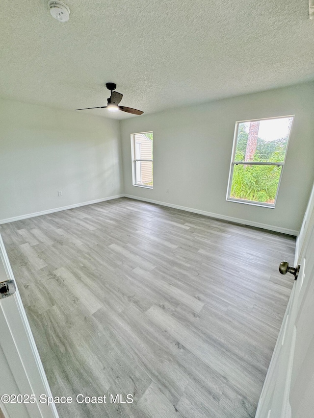 3162 San Salvador Ave, Palm Bay, FL 32909 - spare room with wood finished floors, ceiling fan, a textured ceiling, and a smoke detector