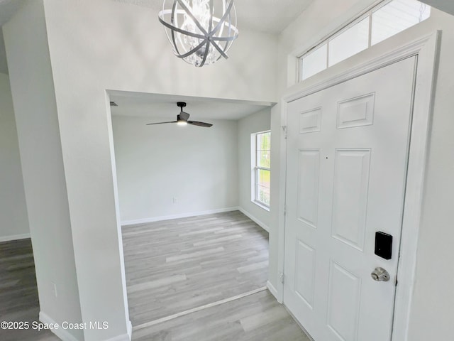 3162 San Salvador Ave, Palm Bay, FL 32909 - foyer entrance featuring a chandelier, wood finished floors, and a ceiling fan