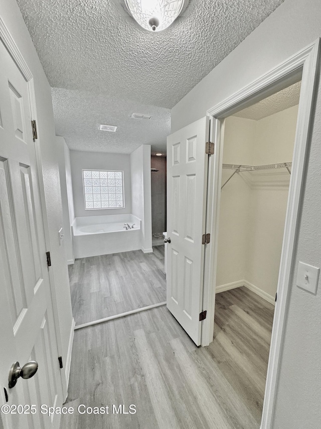 3162 San Salvador Ave, Palm Bay, FL 32909 - hallway featuring wood finished floors and a textured ceiling