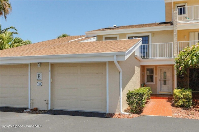 101 La Costa St Unit 2B, Melbourne Beach, FL 32951 - view of property featuring stucco siding, a balcony, and roof with shingles