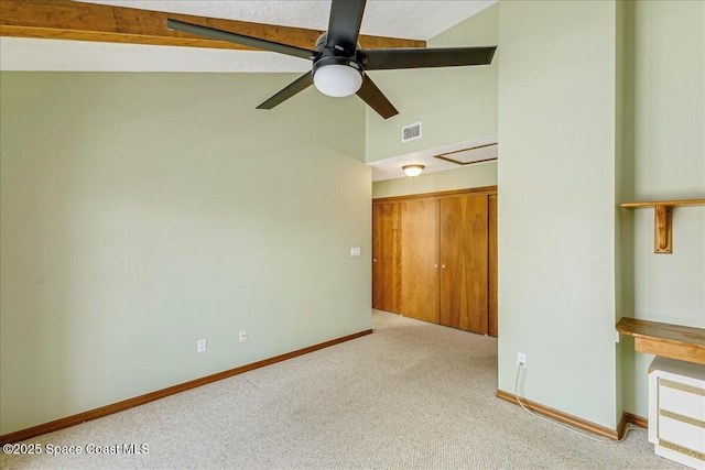 101 La Costa St Unit 2B, Melbourne Beach, FL 32951 - spare room with carpet floors, vaulted ceiling, and ceiling fan