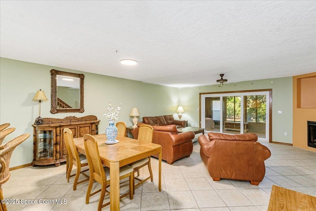 101 La Costa St Unit 2B, Melbourne Beach, FL 32951 - dining room with light tile patterned floors, a fireplace, and a textured ceiling