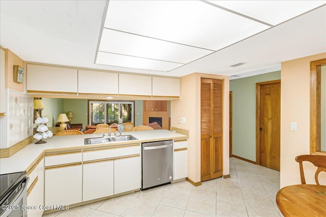 101 La Costa St Unit 2B, Melbourne Beach, FL 32951 - kitchen featuring appliances with stainless steel finishes, light countertops, light tile patterned flooring, and white cabinets