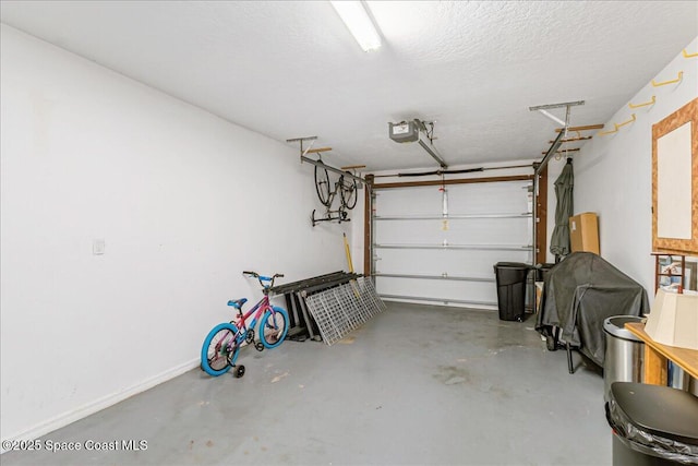 101 La Costa St Unit 2B, Melbourne Beach, FL 32951 - garage featuring a garage door opener and baseboards