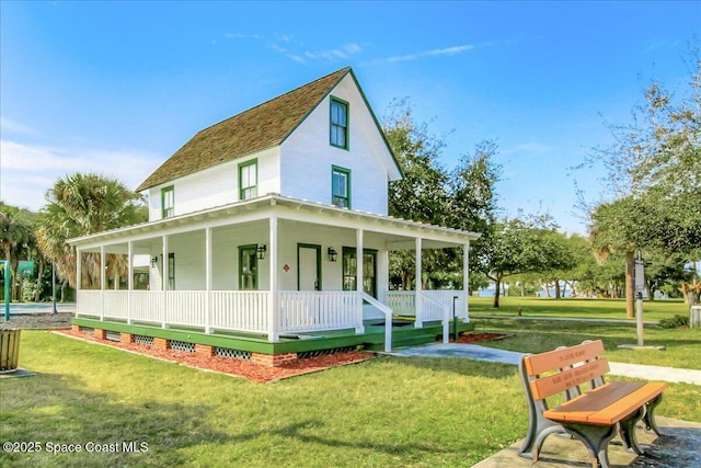 101 La Costa St Unit 2B, Melbourne Beach, FL 32951 - back of house with a porch and a lawn