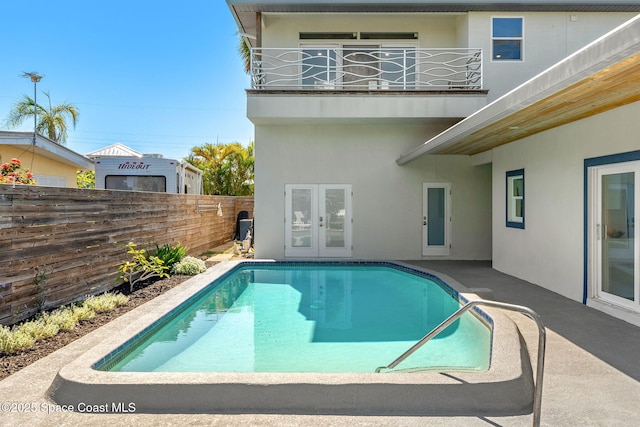 29 Azalea Dr, Cocoa Beach, FL 32931 - view of swimming pool featuring french doors and a fenced backyard