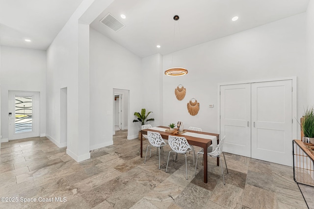 29 Azalea Dr, Cocoa Beach, FL 32931 - dining space featuring high vaulted ceiling, light stone finish floors, and recessed lighting