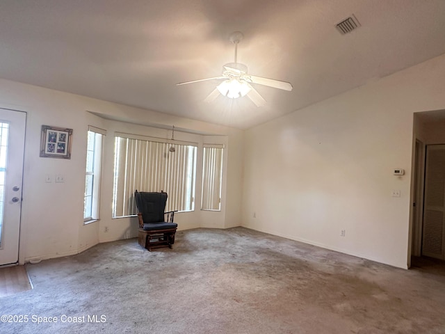 1765 Tatum Blvd, New Smyrna Beach, FL 32168 - unfurnished living room featuring ceiling fan and carpet flooring